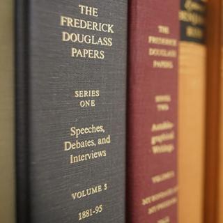 A close-up image of a book shelf with The Frederick Douglass Papers - Series 1 Volume 5 in focus and the other books out of focus.